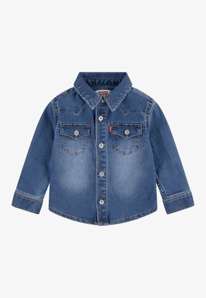 Denim shirt in medium blue with a pointed collar, long sleeves, button closure, and two chest pockets. Features contrasting stitching.