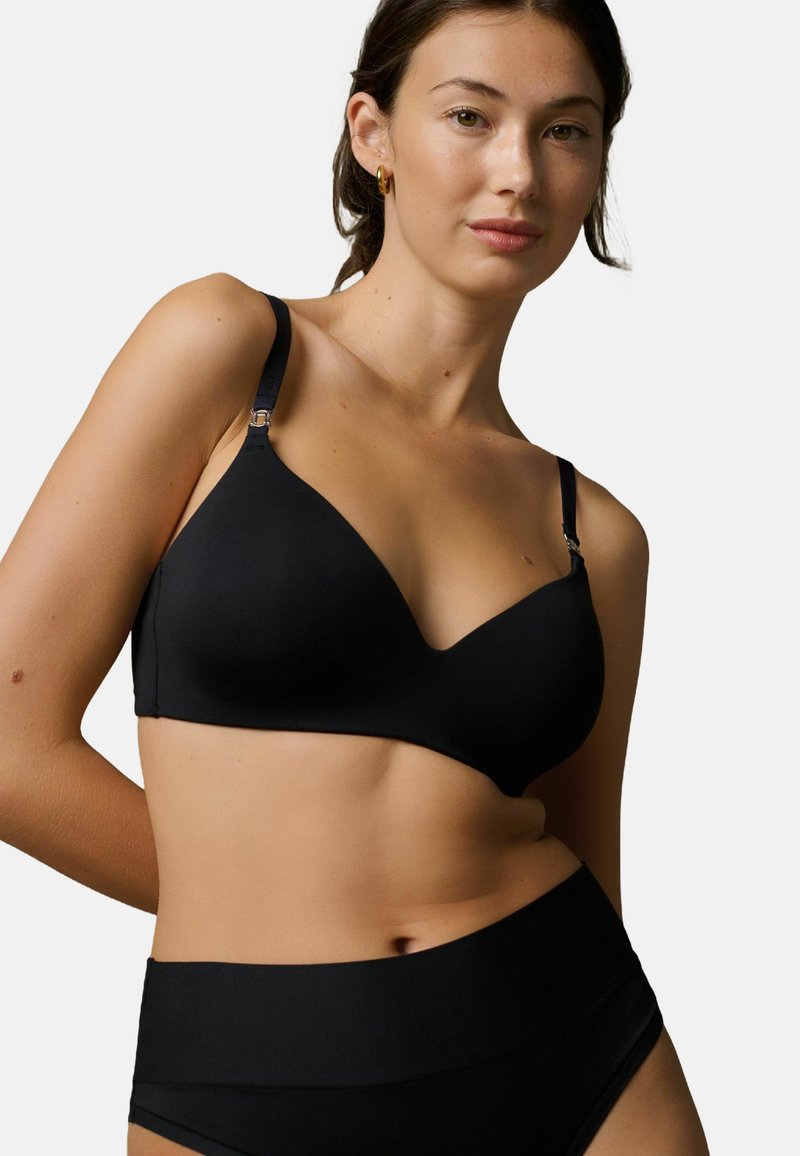 Crni grudnjak s glatkom, mekanom teksturom, s dizajnom bralette i podesivim naramenicama. V-izrez i minimalistički stil.