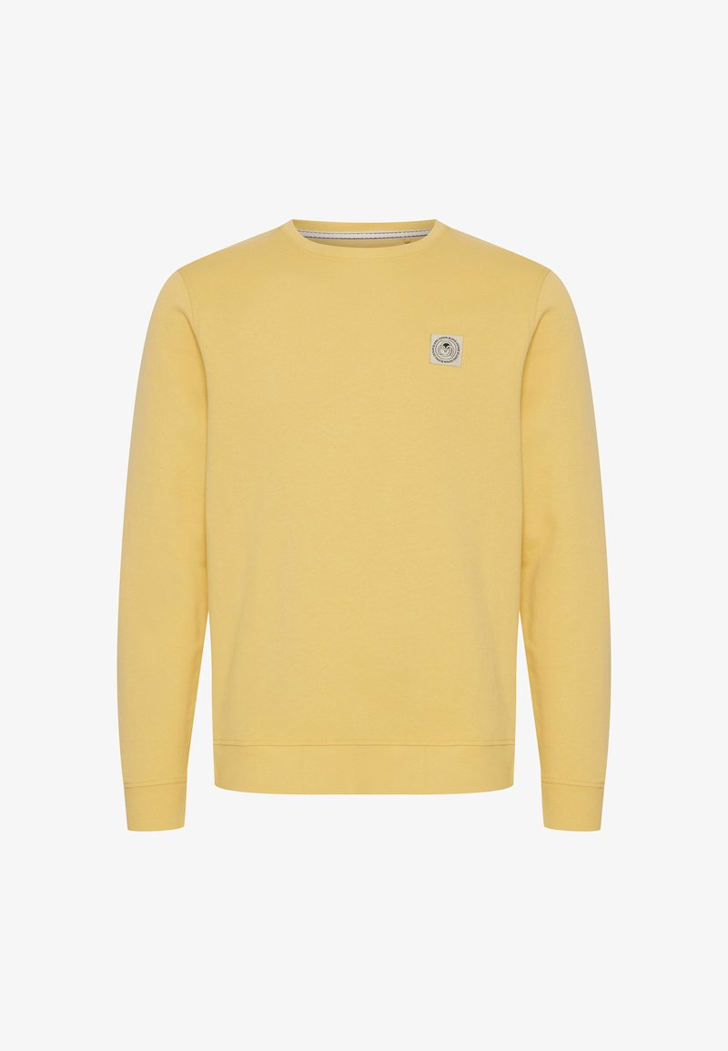 Sweat-shirt jaune à manches longues avec col rond, poignets côtelés et petit écusson carré avec logo sur le côté gauche de la poitrine.