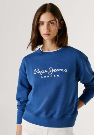 Plava pamučna majica dugih rukava s bijelim logotipom "Pepe Jeans London" preko prsa. Rebrasti manšeti i rub.