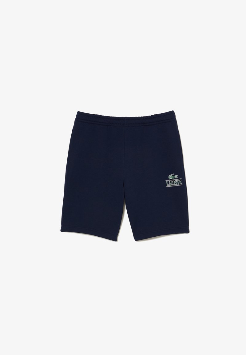 Shorts bleu marine en tissu mélangé coton, avec une taille élastique, un écusson logo sur la jambe gauche et une coupe droite.