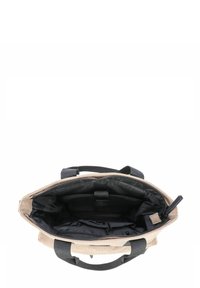 Borsa a spalla in corduroy beige con interno in tessuto nero, doppie maniglie superiori e molteplici tasche interne per l'organizzazione. Design senza chiusura.
