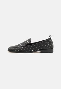 Black leather loafers with a rounded toe, adorned with silver studs. Features a low heel and a pull tab at the back for easy wear.