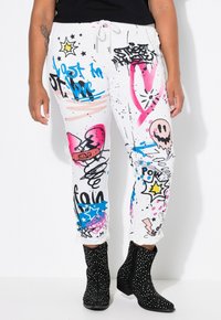 Weiße, gemusterte Sweatpants mit bunten Graffiti-Designs in Pink, Blau und Schwarz, mit einem Kordelzug am Bund und elastischen Bündchen.