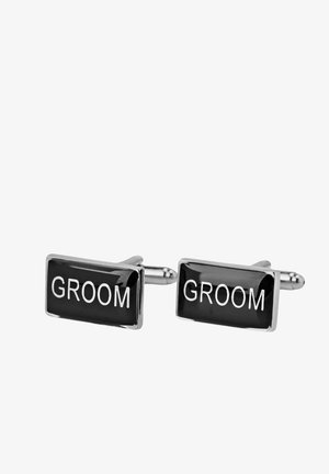 Svarta rektangulära cufflinks med ordet "GROOM" i fet vit text, med en polerad silverram och en slät, glansig yta.