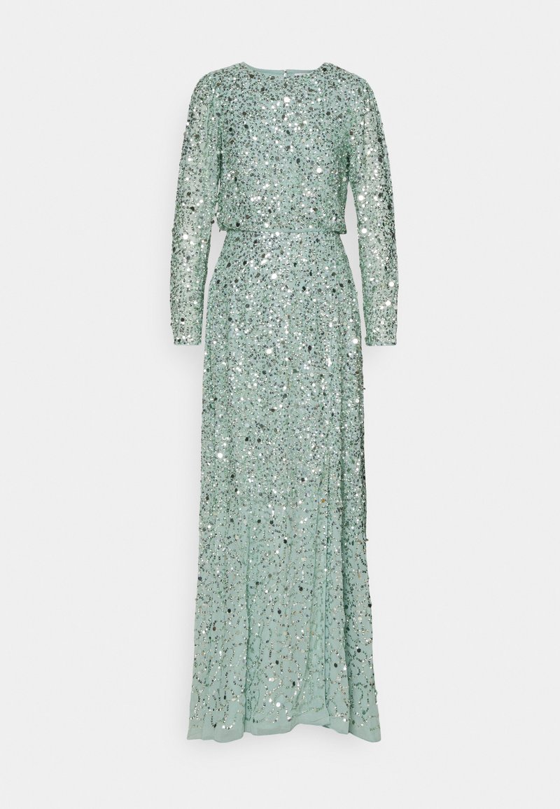 Dlouhá, mátově zelená flitrová večerní šaty s dlouhými rukávy, kulatým výstřihem a přiléhavým pasem. Materiál má celoplošný třpytivý vzor.