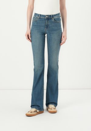 Flared blue jeans made of denim, featuring a mid-rise waist, five-pocket design, and subtle whiskering on the front legs.