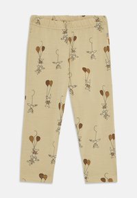 Beige színű gyerek leggings vidám nyuszi és kutya figurákkal, akik barna lufit tartanak, az egész anyagon.