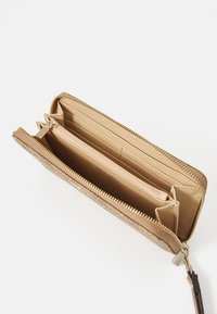 Gold glitter wallet with a zip closure, featuring multiple card slots and a coin compartment. Textured exterior and smooth interior.