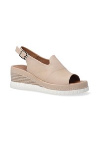 Light beige leather wedge sandal with open toe, slingback strap, and textured cork-style midsole. White rubber outsole with defined grooves.