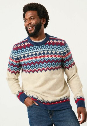 Sweater featuring a cream base with a colorful Fair Isle pattern in blue, red, and navy. Ribbed cuffs and neckline. Warm knit texture.