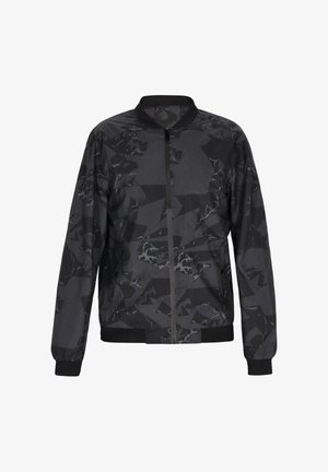 Fekete bomber dzseki geometrikus mintával, könnyű anyagból készült. Elől cipzárral, valamint bordázott mandzsettákkal és passzéval rendelkezik.