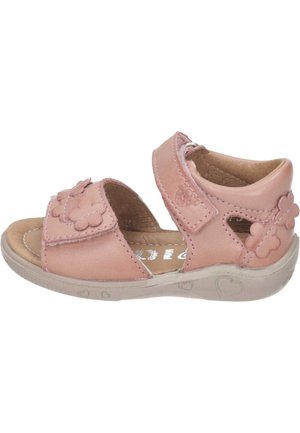Pink leather sandals with flower accents, velcro straps, open sides, and a textured beige sole displaying heart designs.