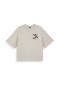 Camiseta beige de manga corta extragrande con cuello redondo, con un pequeño diseño ornamental oscuro en forma de "S" en el pecho izquierdo.