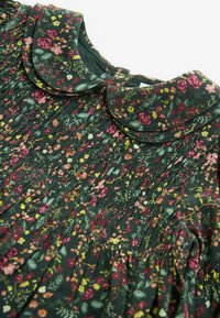 Abito floreale con sfondo verde, caratterizzato da un design plissè, un colletto arrotondato e fiori multicolori nelle tonalità di rosa, giallo e rosso.