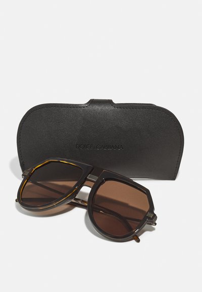 Dolce & Gabbana sunglasses with a brown tinted lens, tortoiseshell-patterned frames, and a black leather case featuring embossed logo.
