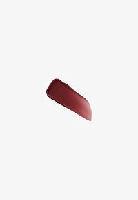 Échantillon de rouge à lèvres marron avec une texture lisse sur un fond blanc uni.