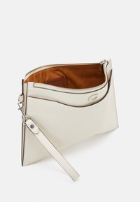 Grädde läderkuvertväska med bruna accenter, dragkedjeslutning och avtagbar axelrem. Inuti finns en mjuk brun foder.