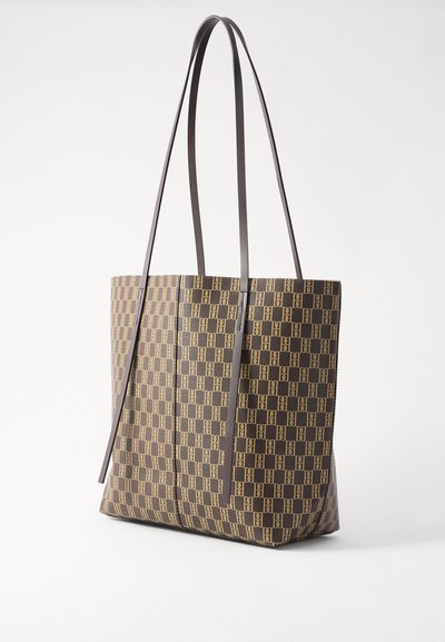 Brązowa torba na ramię z wzorem w kratkę, z długimi uchwytami i gładką teksturą powierzchni. Solidna konstrukcja bez widocznych elementów metalowych.