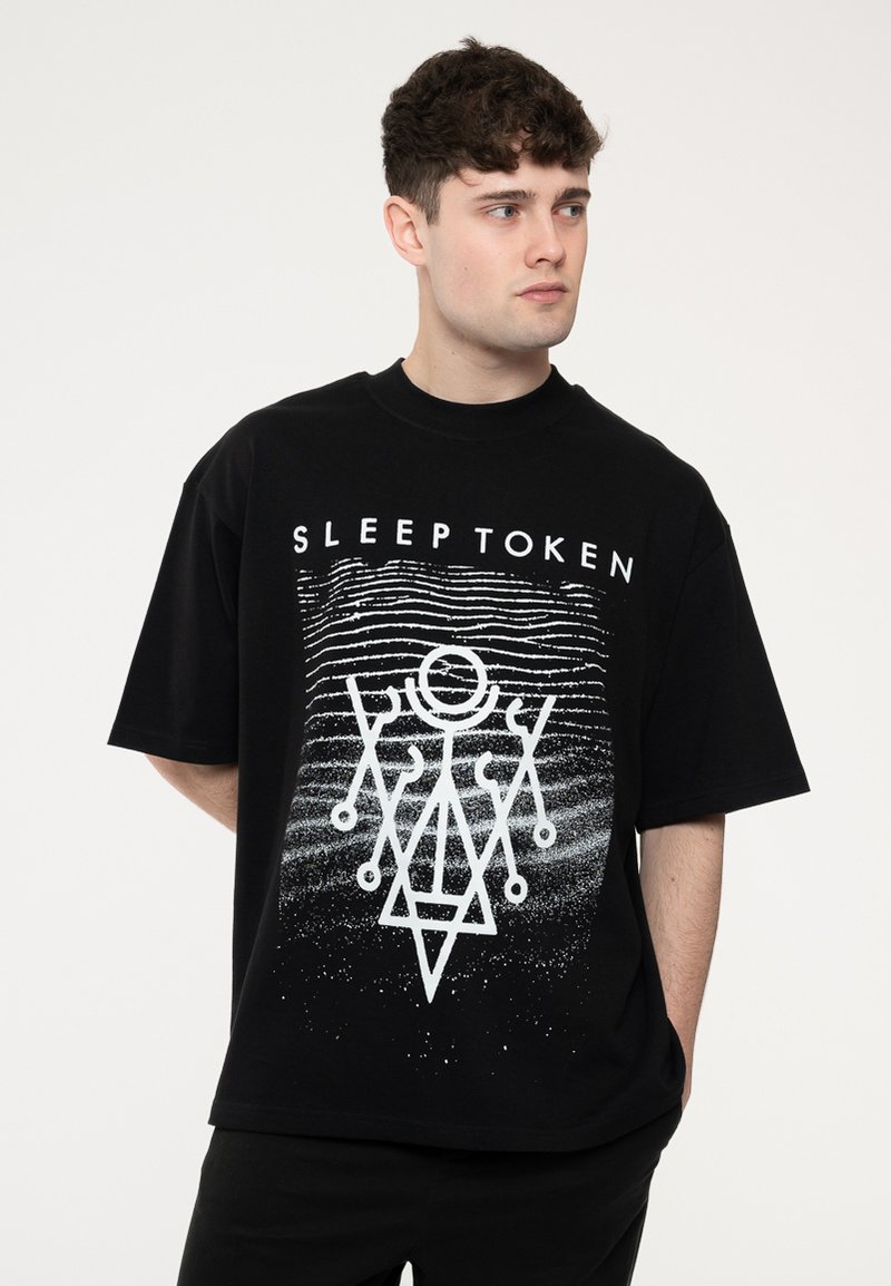 Black cotton t-shirt featuring a white graphic design with geometric patterns and the text "SLEEP TOKEN" above. Short sleeves and relaxed fit.
