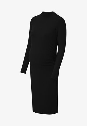 Zwarte geribde zwangerschapsjurk met lange mouwen, hoge halslijn en geraffineerde details bij de taille voor flexibiliteit en comfort. Soepele textuur.
