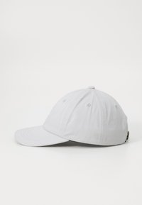 Light gray baseball cap made of soft fabric, featuring a curved brim, side stitching, and a back closure detail. Simple design with no pattern.