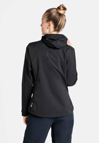 Black waterproof jacket with a hood, featuring smooth texture and a fitted design, shown from the back with a logo accent at the hem.
