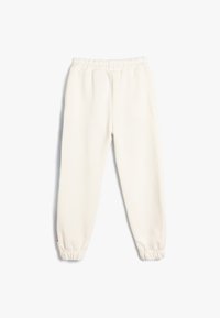 Cremfarbene Sweatpants mit einem elastischen Bund, gerippten Knöcheln und einer glatten Textur. Besitzt ein dezentes Logo an der Seite.