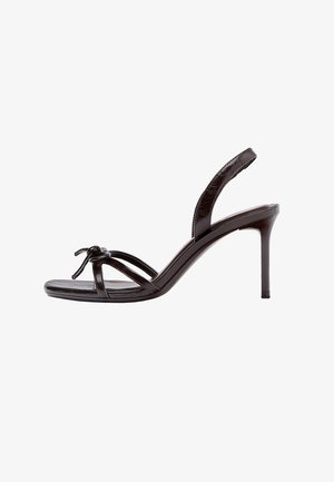 Dark brown leather high-heeled sandal with thin straps, an ankle slingback, and a small bow detail at the front.
