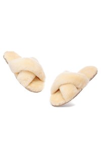 Faux fur open-toe slippers in light beige with an overlapping crisscross design, featuring a flat sole and soft, plush texture.