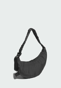 Black fabric shoulder bag with a curved, puffy design. Features a gathered strap and adjustable hardware for comfort and fit.