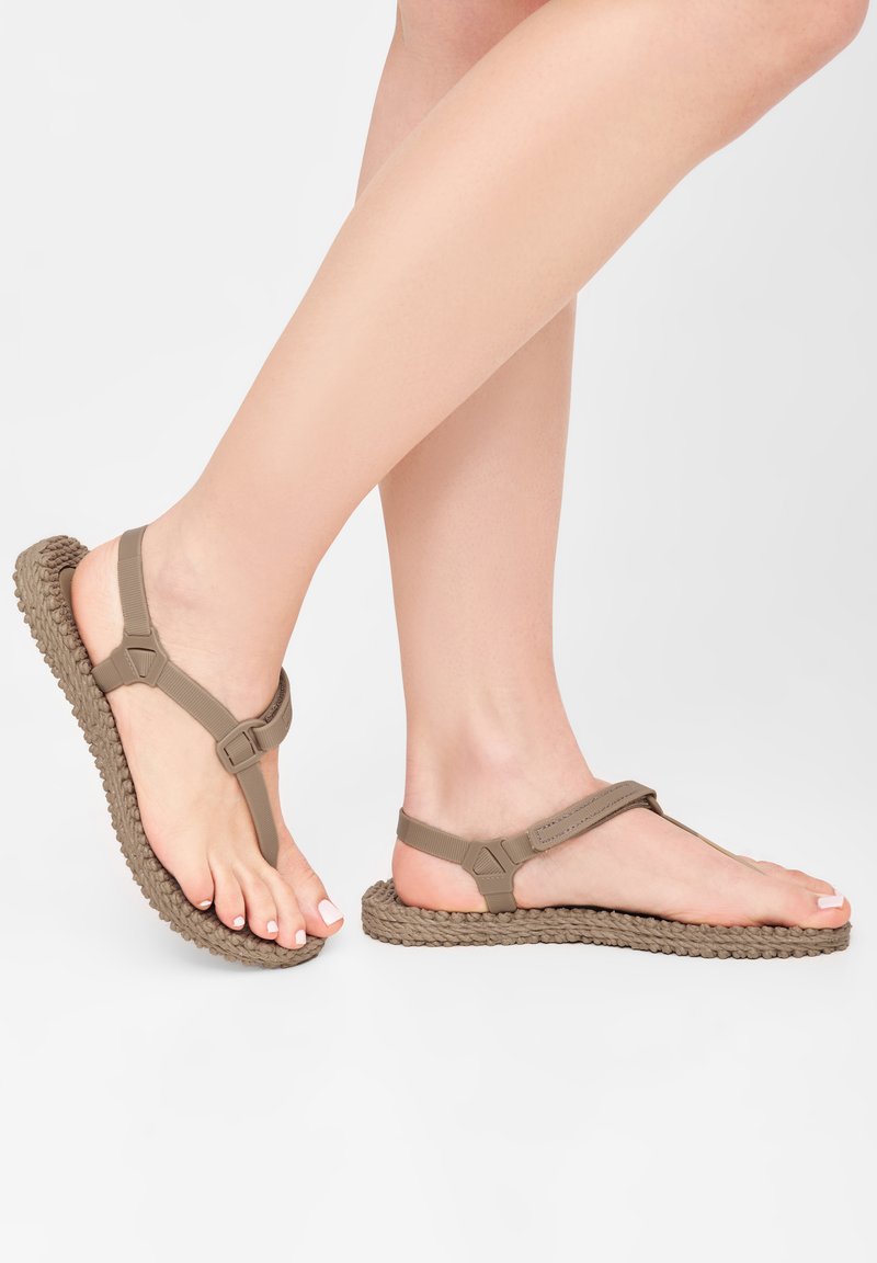 Brown synthetic sandals with a braided sole and T-strap design. Features adjustable ankle strap and textured footbed for grip.