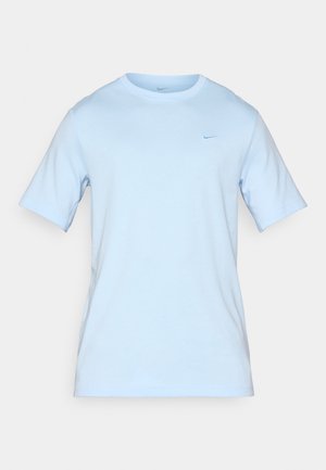 Light blue cotton t-shirt with a crew neck and short sleeves. Features a small, embroidered logo in a slightly darker blue. Minimalist design.