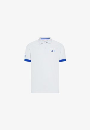 Polo blanco de manga corta con bordes azules en las mangas, un pequeño triángulo azul y un símbolo de X en el pecho, y el número 8 en la manga derecha.