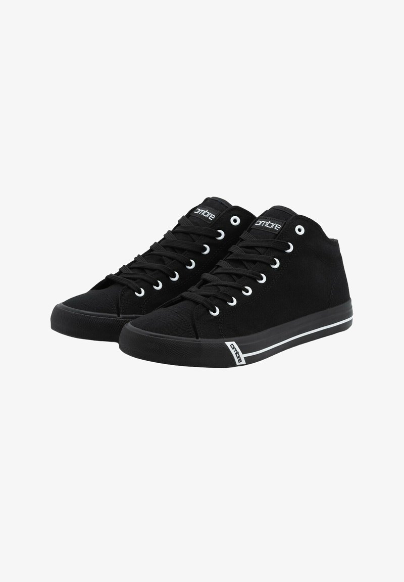 Pár černých vysokých plátěných tenisek s bílými očky, černými tkaničkami a značkovými štítky na jazyku a okraji podrážky.