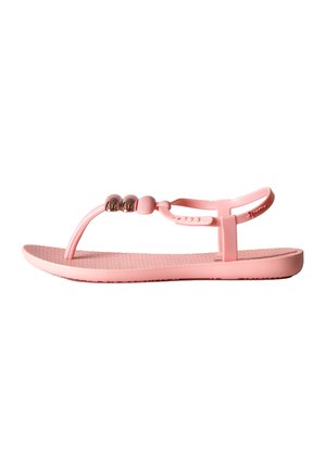 Sandali rosa con suola in gomma testurizzata, cinturino stile infradito e tre decorazioni a perla metallica sulla parte superiore. Design minimalista, materiale flessibile.