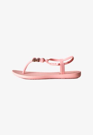 Sandali rosa con suola in gomma testurizzata, cinturino stile infradito e tre decorazioni a perla metallica sulla parte superiore. Design minimalista, materiale flessibile.