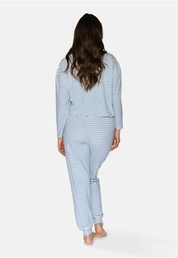 Blå- och vitrandig pyjamasuppsättning, med långärmad tröja och byxor med elastiska muddar. Mjuk tyg; avslappnad passform med en enkel design.