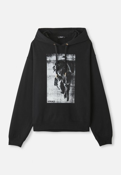 Sudadera negra de algodón, con un estampado gráfico de un perfil en gris y blanco, y herrajes de cordón en tono dorado.