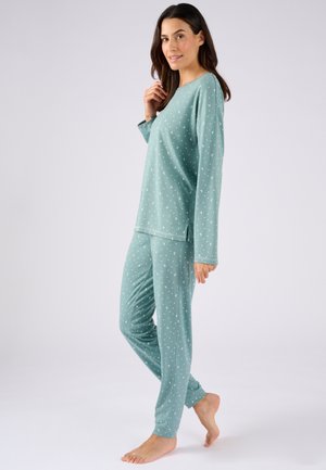 Set di pigiama verde composto da maglia a maniche lunghe e pantaloni, realizzato in morbido tessuto con motivi di lune crescenti bianche. Vestibilità comoda con fenditure laterali.
