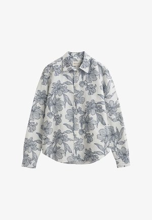 Άσπρο πουκάμισο με μακριά μανίκια και κουμπιά, με μαύρο ανθικό σχέδιο και μυτερό γιακά, τοποθετημένο πλαγίως σε λευκό φόντο.