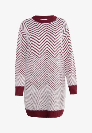 Pletený sveter v bielej a bordovej farbe s chevronovým vzorom, s okrúhlym výstrihom a rebrovanými rukávmi a spodným lemom. Voľný strih.