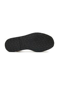 Black rubber shoe sole with a textured pattern for grip, featuring a smooth edge and central logo imprint.