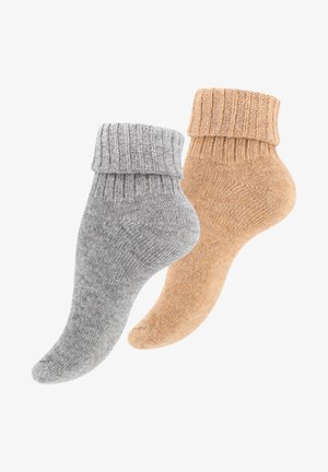 Two pairs of crew socks: one gray with a ribbed cuff and one tan with a similar cuff. Both have a soft, textured knit finish.