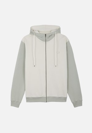Lysegrå og off-white hættetrøje med lynlås foran, snøre i hætten samt ribkant ved ærmer og bund.