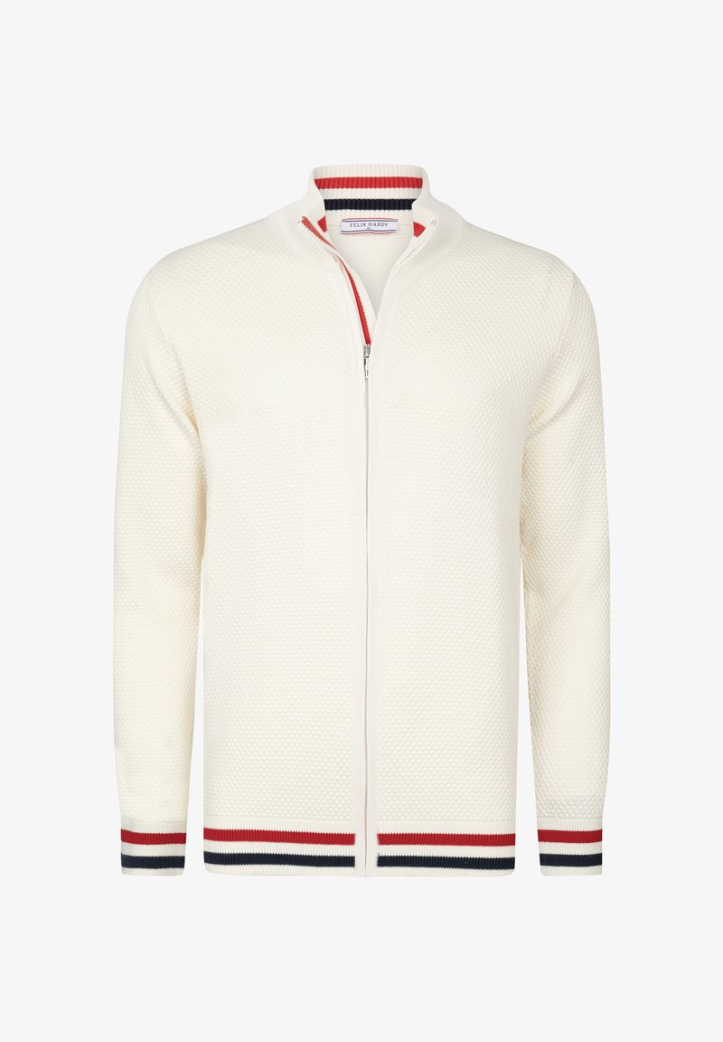 Kreemikas zip-up kardigan tekstureeritud kudumise mustriga, millel on punavad ja mereväe sinised triibulised aktsendid krael ja varrukaotsadel.