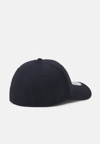 Navy blue baseball cap featuring a rounded crown, stitched detailing, and ventilation eyelets. Brim is slightly curved for sun protection.