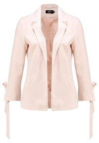 Blazer rose clair en tissu lisse avec manches longues, accents noués aux poignets et deux poches avant. Ouverture devant sans boutons.