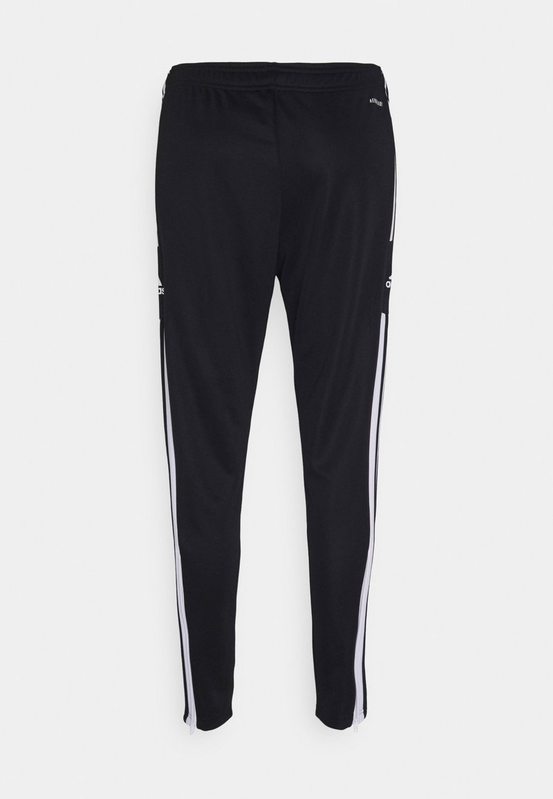 Pantalons de sport noirs avec des bandes blanches sur les côtés, en matériau extensible, dotés d'une taille élastique et de fermetures éclair aux ourlets.