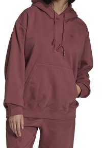 Felpa con cappuccio color bordeaux, dotata di tasca frontale, cordino regolabile e polsini a coste. Realizzata in materiale morbido, presenta un piccolo dettaglio con logo.